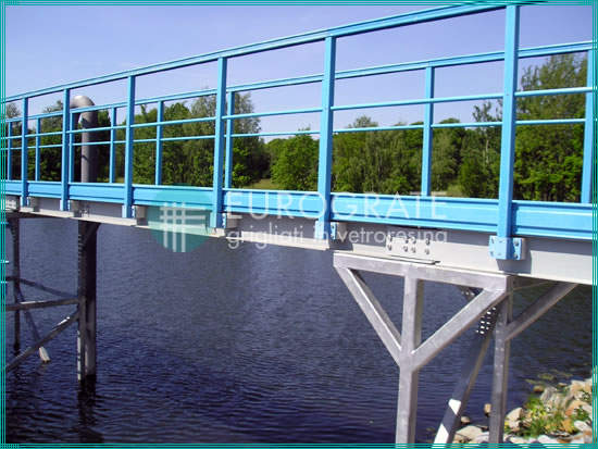 bridge with safety handrails in the basin of a water treatment plant