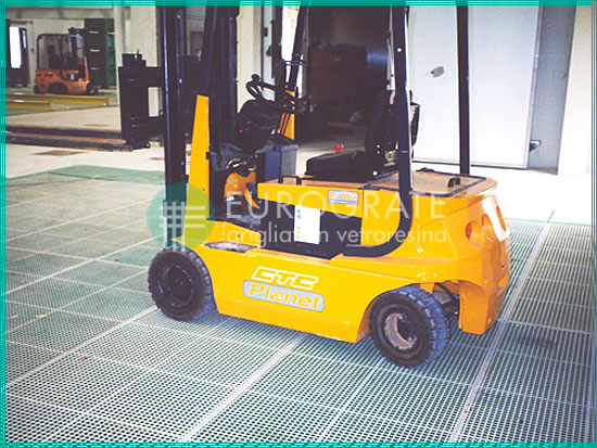 electric forklift truck working on a grated floor